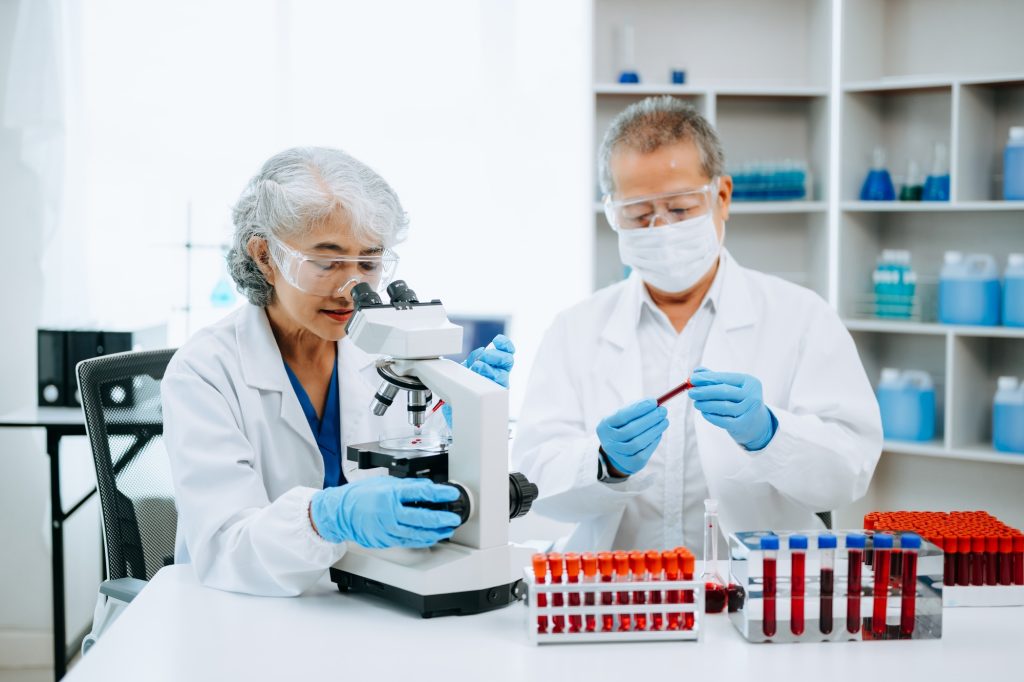 Scientist team meeting and writing analysis results in the laboratory